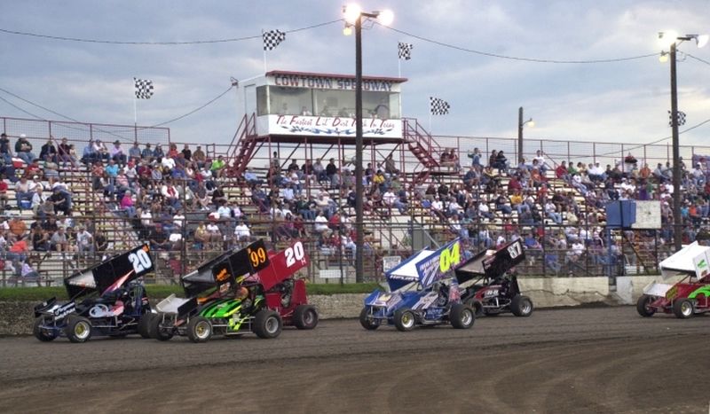 An American Bank of Oklahoma ASCS Sooner Region heat race paces before a packed grandstand at Cowtown Speedway in Kennedale, TX, on Saturday night.