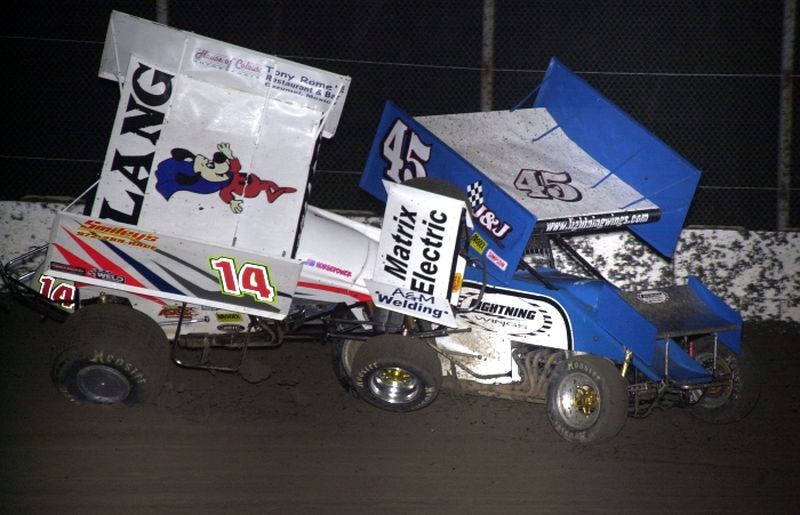 Michael Lang (14) led the opening half of Friday night's American Bank of Oklahoma ASCS Sooner Region feature at Kennedale Speedway Park before this tangle with J.P. Bailey (45) derailed his bid for a first series win.