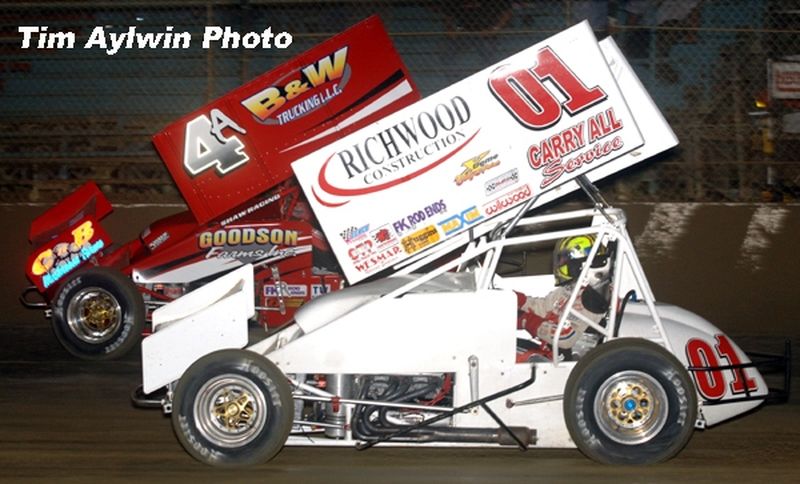 Kenny Adams (4a) makes a late move around Gary Wright (01) to win Thursday night's 25-lap O'Reilly American Sprint Cars on Tour National feature event at East Bay Raceway Park's 32nd Annual Winter Nationals in Tampa, FL  Photo courtesy of Tim Aylwin