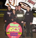Jason Johnson and crew enjoy O'Reilly ASCoT victory lane after topping Saturday night's State Fair Speedway Spring Nationals 30-lap finale in Oklahoma City.